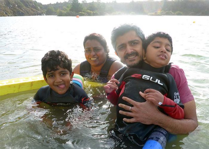 Family swimming with SEND child