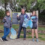 CST team posing with litter picked from beach clean