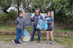 CST team posing with litter picked from beach clean